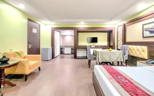 a hotel room with a bed and a dining room at Me Q Beach Hotel & Apartment in Da Nang