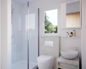 a white bathroom with a toilet and a sink at Camping Nord in Klopein am Klopeiner See +17 photos