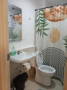 a bathroom with a toilet and a sink at BRIA Flat Condo in Kauswagan +12 photos