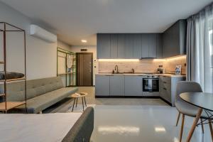 a kitchen and living room with a couch and a table at La Shara Building in Sofia