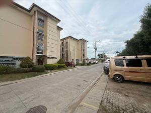 a van parked on the side of a street at BRIA Flat Condo in Kauswagan