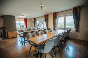 a conference room with a large wooden table and chairs at Le Milan Royal 26 pers, Malmedy, Balnéo, vue, calme in Malmedy