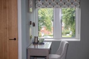 a window in a room with a table and a chair at Redstones in Dufton