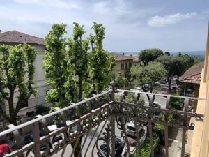 a balcony view of a street with trees and cars at San Prospero Heritage in Siena