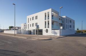 a white building on the side of a street at Oliva Suites in Oliva