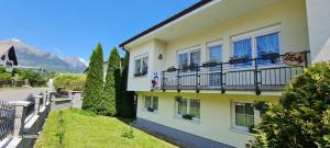 a yellow building with windows and balconies on it at Ubytovanie Lienka in Nová Lesná