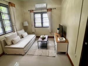 a living room with a couch and a table at One bedroom beach house near Lamai in Hua Thanon Beach