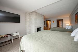 a bedroom with a large bed and a fireplace at 101B One Bedroom One Bath in Oakland +17 photos