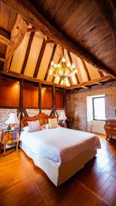 a large bedroom with a large white bed in a room at Château Hôtel La Terrasse - Teritoria in Meyronne