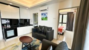 a living room with a couch and a chair at Highland Breeze Hotel in Genting Highlands