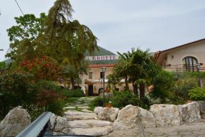 a building with a stone path in front of a building at Hotel La Grotte in San Donato Val di Comino