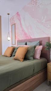 a bed with several pillows on it in a bedroom at New! Sea View Apartment with Aircon in Center of Las Americas in Playa de las Americas +19 photos