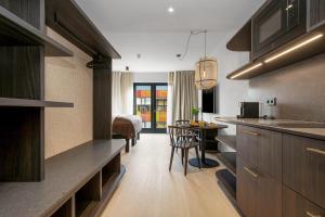 a kitchen with a table and a dining room at Strand Hotel Apartments in Hafnarfjördur +52 photos