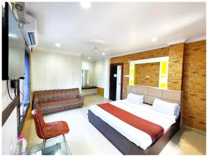 a hotel room with a bed and a couch at SEA VIEW FAMILY FRIENDLY HOTEL S-S Piper ! - Room with Balconies, Restaurant, Parking & Free Wi-Fi ,Beach Front Location - Best Seller Hotel In Puri in Puri
