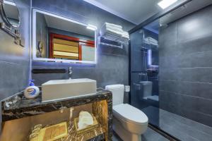 a bathroom with a sink and a toilet and a shower at Hangzhou Elegant Holiday Inn in Hangzhou