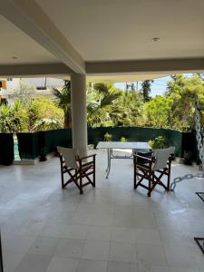 a patio with a table and chairs on a patio at Oasis 3 minutes from the beach in Vari