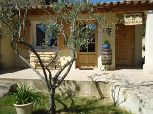 a house with a tree in front of a door at Gite Pellerin in Montbrison-sur-Lez