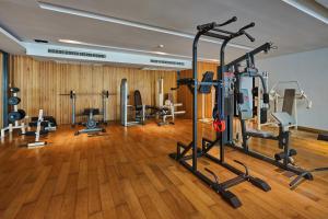 a gym with several treadmills and machines in a room at Welcome World Beachfront Resort in Pattaya South