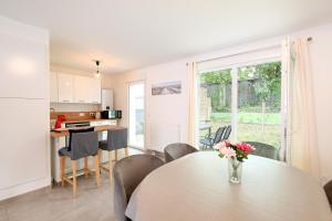 a kitchen and dining room with a table and chairs at Bienvenue - 500 m de la plage in Courseulles-sur-Mer