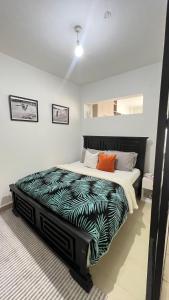 a bedroom with a large bed in a room at Cozy Home at Sky garden kirawa rd in Nairobi
