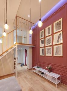 a living room with red walls and a staircase at Duplex Apartment in Mons Center 3 in Mons
