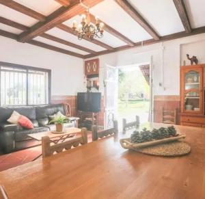 a living room with a table and a couch at Spacious Villa in Guillena with Garden and Private Pool in Guillena