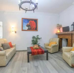 a living room with two couches and a table at Spacious Villa in Guillena with Garden and Private Pool in Guillena