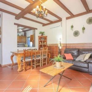 a living room with a table and a couch at Spacious Villa in Guillena with Garden and Private Pool in Guillena
