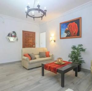 a living room with a couch and a coffee table at Spacious Villa in Guillena with Garden and Private Pool in Guillena