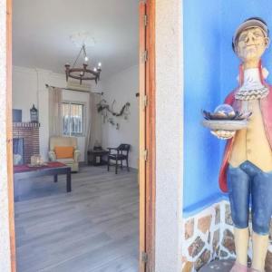 a painting of a woman holding a bowl of fruit in a living room at Spacious Villa in Guillena with Garden and Private Pool in Guillena