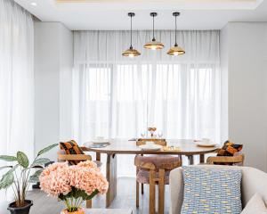 a dining room with a table and chairs at Escada Studio & 2-bedroom, Rooftop Lounge & Restaurant, Swimming Pool, Gym, Workspace, Wonderiss Properties Westlands Living in Nairobi