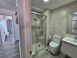 a bathroom with a shower and a toilet and a sink at Rincon de Maruca Atico C in Gran Tarajal +40 photos