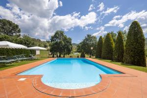 a swimming pool in a yard with trees at Campo Grande by VacaVilla in Santa Cristina