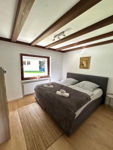 a bedroom with a large bed with two towels on it at Villa Eifelblick Loft-Apartment in Heimbach +16 photos