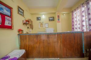 a hospital room with a wooden counter and a room with aerate at Hotel O Siljong in Gangtok