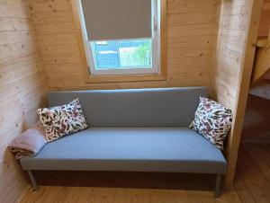 a couch in a small room with a window at Starkowo pod lasem in Starkowo