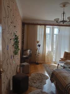 a living room with a couch and a table at Просторная, двухкомнатная квартира ,с великолепным видом на город, расположенная в центре города Баку in Baku +18 photos