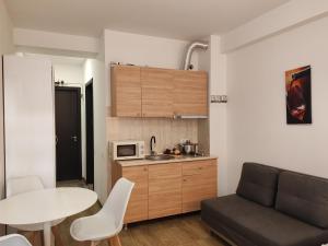a living room with a table and a kitchen at Tribu in Bakuriani