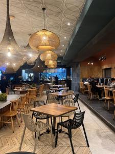 a restaurant with tables and chairs and people sitting at tables at Lagoon - The Blyde in Pretoria