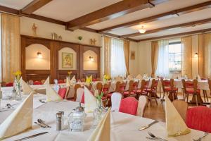 a large room with tables and chairs in it at Landhotel Zum Hammer in Tannenberg