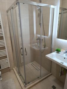 a shower with a glass door next to a sink at Apartman ANATEO Istocno Sarajevo in Vranješ +17 photos