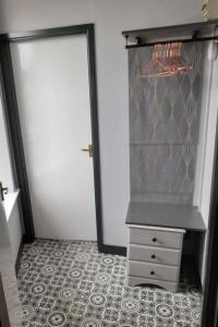 a closet with a door and a dresser in a room at Studio No4, Cockermouth The Lakes in Cockermouth