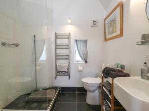 a bathroom with a toilet and a sink and a shower at Little Barn in Royston +19 photos