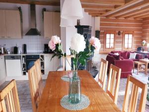 a vase of flowers on a table in a kitchen at Private Pool Villa in Stupna in Pecka +32 photos