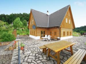 a large wooden house with a picnic table on a patio at Private Pool Villa in Stupna in Pecka