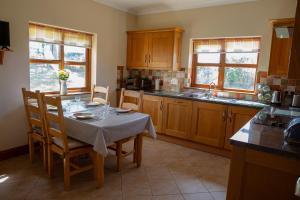 a kitchen with a table and chairs and a kitchen with a table and chairsktop at Aberystwyth Dinas Cottage in Llanilar