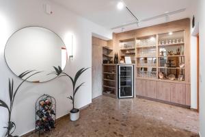 a room with a large mirror and a refrigerator at SISTERS Haus Hotel Garni in Jennersdorf