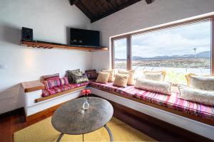 a living room with a couch and a large window at Casa de Hilario in Yaiza