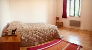 a bedroom with a bed and a wooden floor at Au bord de l eau in Pesmes