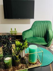 a living room with a green couch and a table at Lagoon - The Blyde in Pretoria